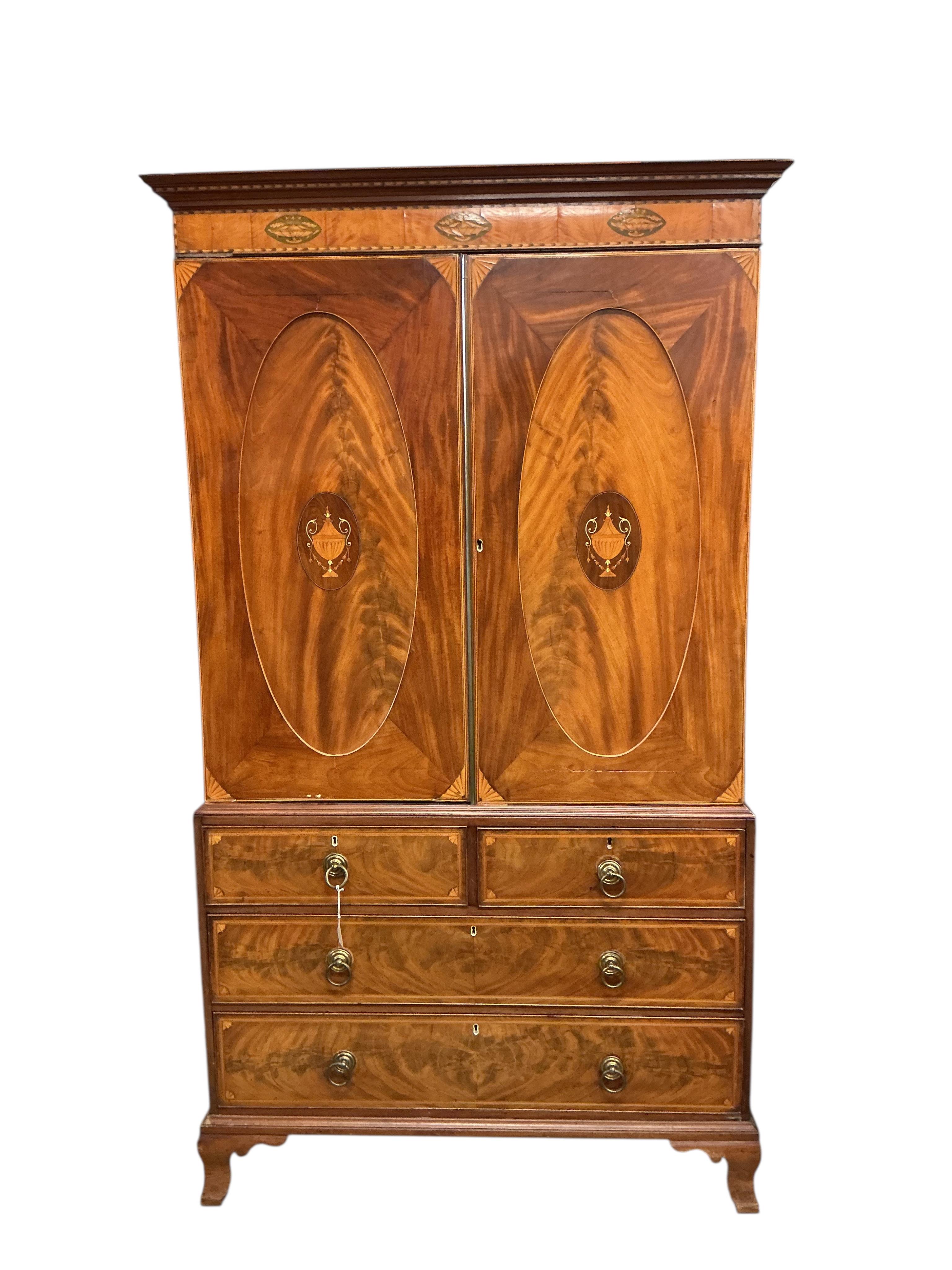 A George IV marquetry inlaid mahogany linen press, width 124cm, depth 60cm, height 223cm
